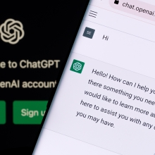 ChatGPT on a smartphone with the OpenAI logo in the background