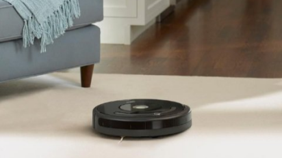 iRobot robot vacuum cleaning a living room.