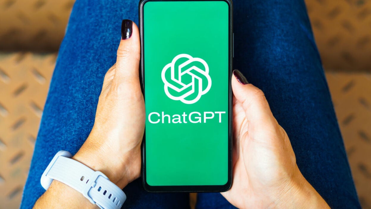 ChatGPT on a smartphone in a woman's lap
