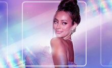 A photo of Emira D'Spain glammed up and looking over her shoulder, photoshopped on a blue, purple, and pink background. 