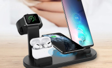 multiplatform charging station holding and charging an iphone, airpods, smart watch, and android phone