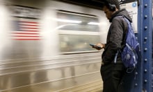 Subway rider checks his phone