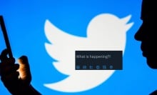 silhouette holding phone in front of twitter logo and a screenshot of twitter prompt reading "what's happening"  