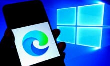 Microsoft Edge logo on phone screen next to Windows logo