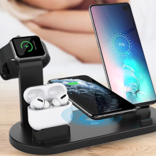 multiplatform charging station holding and charging an iphone, airpods, smart watch, and android phone