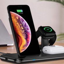 wireless charging hub charging up an iphone, a smartwatch, and airpods.