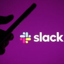 Slack logo with a silhouetted hand holding a phone 