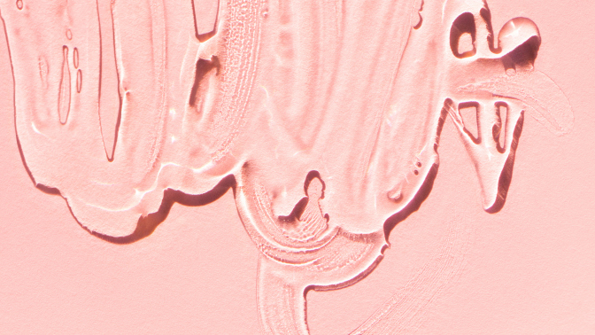 A close up of lube on a light pink background. 