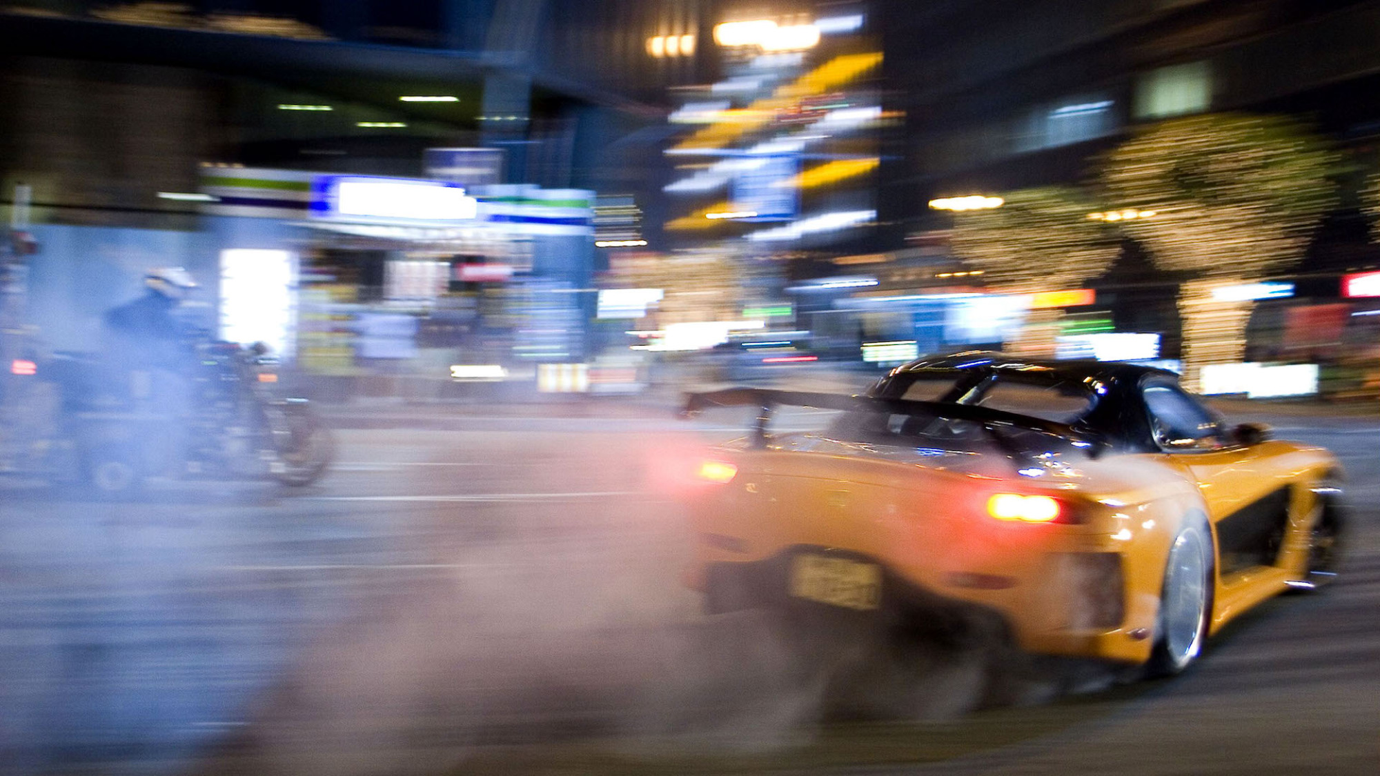 A still from "Tokyo Drift" showing a car drifting in the middle of the city.