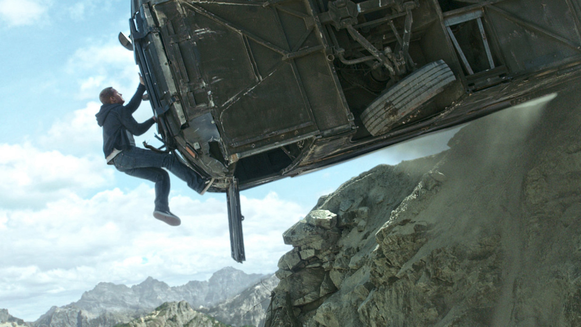Paul Walker climbs up a bus teetering on the edge of a cliff in "Furious 7."