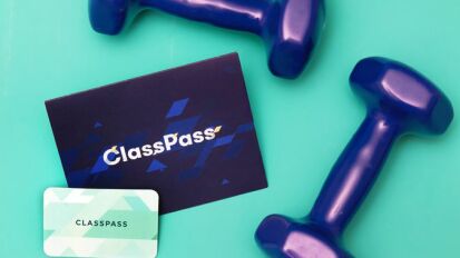 Weights and a ClassPass membership card on a blue background.