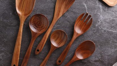 NAYAHOSE wooden cooking utensil set on a dark counter top.