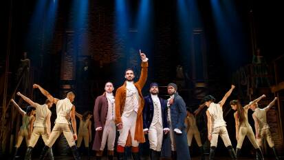 Cast performing "Hamilton" on stage