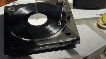 A AUDIO-TECHNICA bluetooth-enabled turntable on a table.