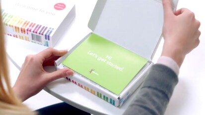 person opening a DNA test kit box