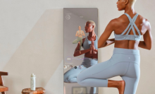 Woman doing yoga in front of a mirror