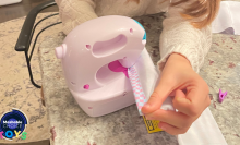 kid sewing on toy sewing machine