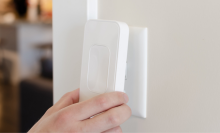 person attaching switchmate 2.0 smart switch plate