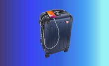dukap hardside spinner suitcase charging phone with blue gradient background