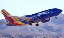 Southwest plane taking off with mountains in background