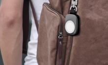 person carrying backpack with apple watch keychain charger on it