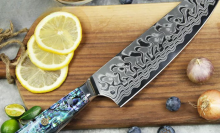 ryori chef knife on cutting board with lemons and other fruit
