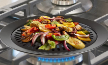 smokeless grill attachment on stove with peppers and onions