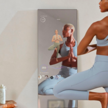 Woman doing yoga in front of a mirror