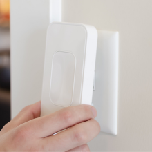 person attaching switchmate 2.0 smart switch plate