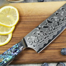 ryori chef knife on cutting board with lemons and other fruit
