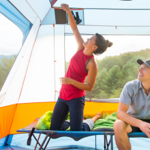 Couple sitting in a tent outdoors 