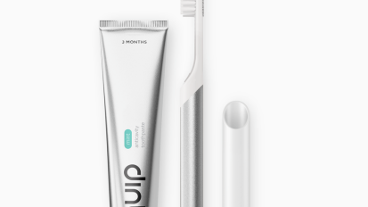 Quip electric toothbrush and toothpaste on a white background