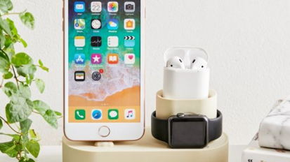 Phone and airpods charging on a elago Charging Hub.