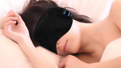 person wearing eye mask while asleep in bed