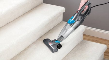 bissell vaccuum being used on carpeted stairs