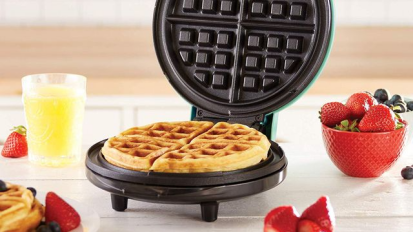Dash mini waffle maker on a kitchen counter.