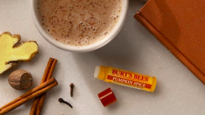 Burt's Bees chapstick and cup of coffee sitting on table