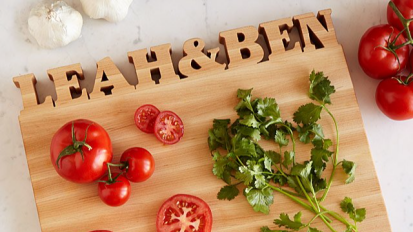 A personalized cutting board on a kitchen counter.