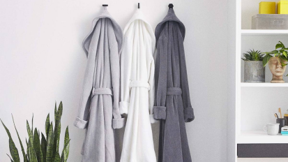 The Brooklinen Super-Plush Robe hanging in a bathroom.