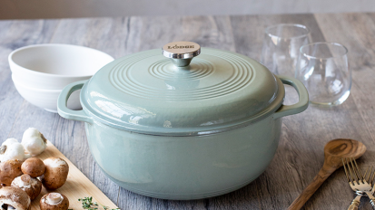A blue Lodge enameled Dutch oven on a kitchen counter.
