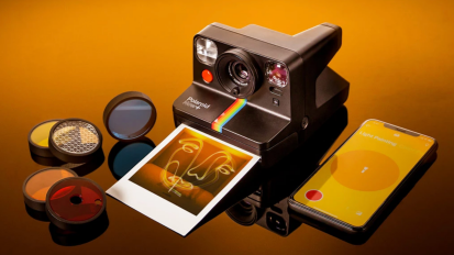 A Polaroid Now+ kit on an orange background.