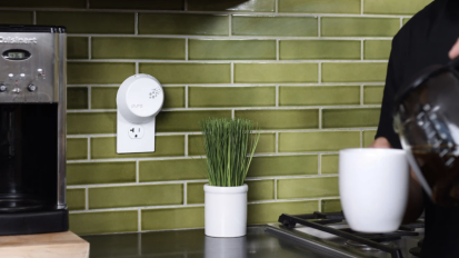 a PURA fragrance diffuser plugged into a kitchen outlet