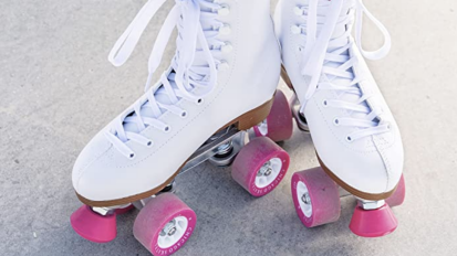 a pair of white roller skates with pink wheels