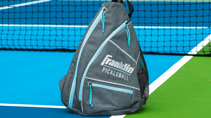 a close-up of a franklin sports pickleball sling bag on a pickleball court
