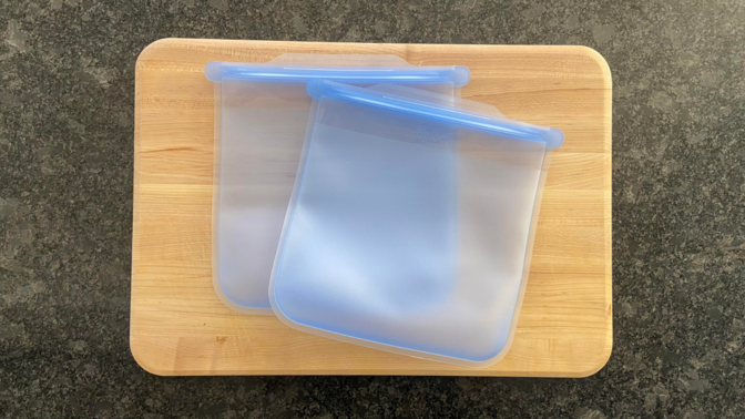 two large ziploc endurables pouches laid flat on a wood cutting board on a black countertop